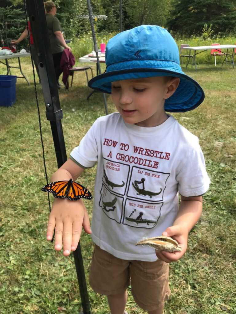 Little child with a butterfly on the hand.